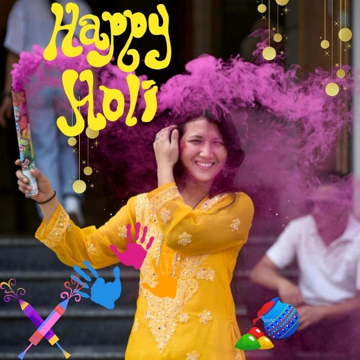 A young girl is celebrating holi with violet color cloud in yellow dress .Happy Holi images.